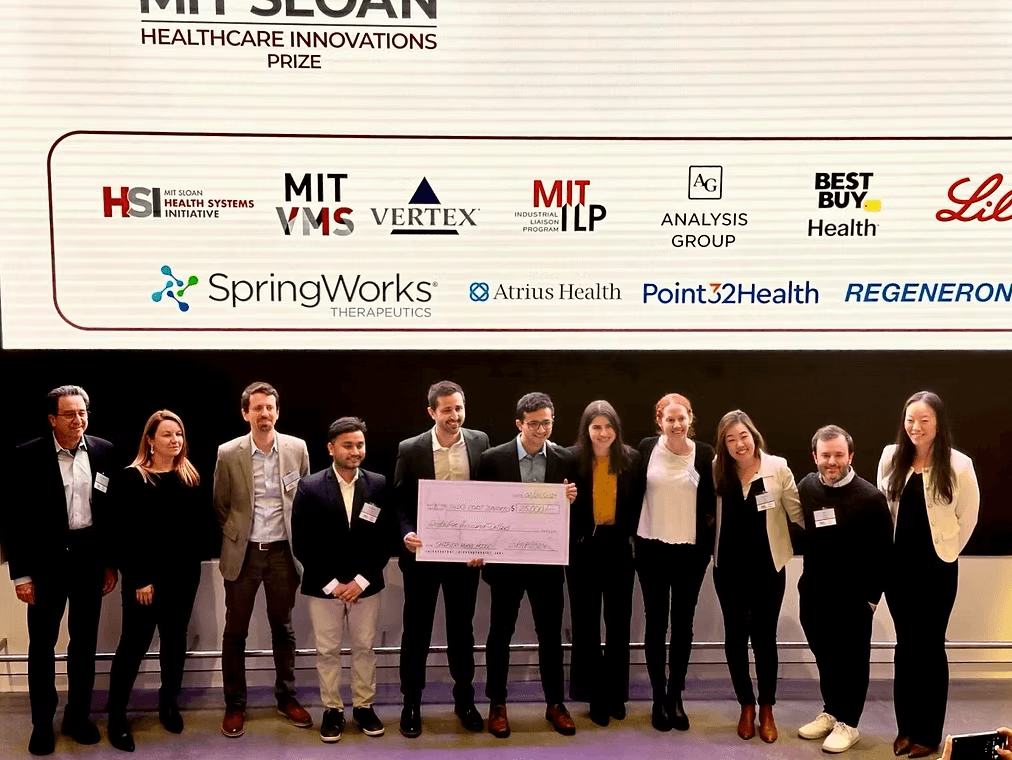 Group photo from the 2024 MIT Sloan Healthcare Innovations Prize ceremony, with award recipients holding the prize check.